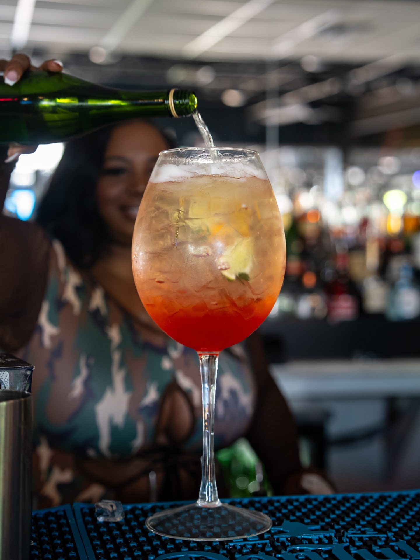 Champagne being poured over a cocktail at the Privilege Houston bar